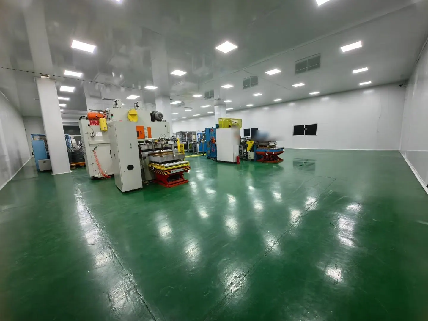 A clean press hall with a green epoxy floor