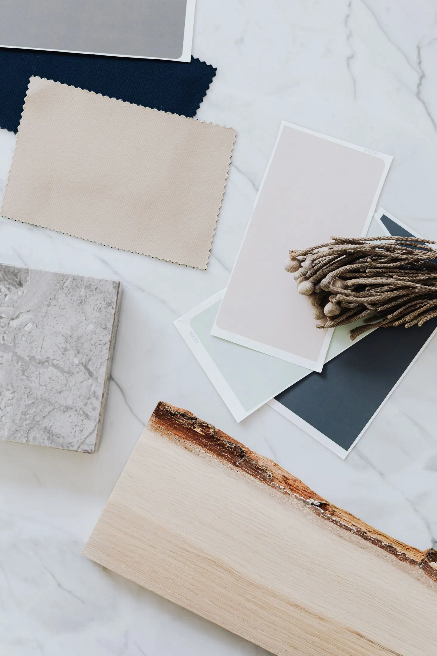 A flat lay of wood, stone, textile and paint samples