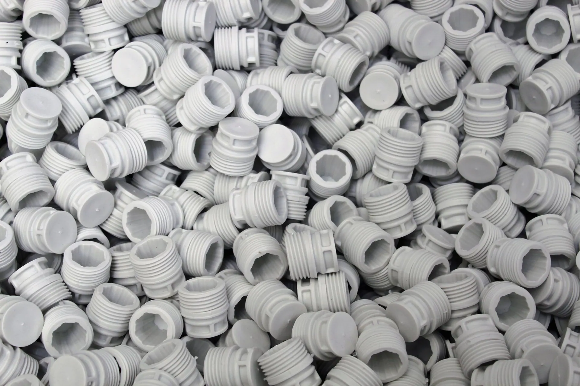 A pile of white molded plastic components